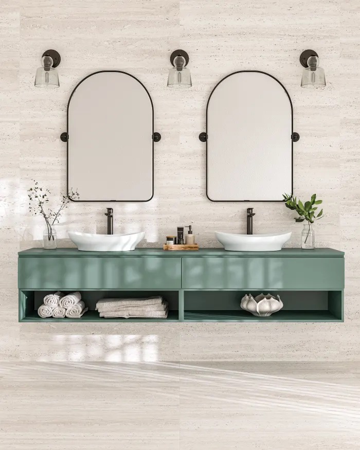 Sage green floating double vanity against travertine-look large format tile